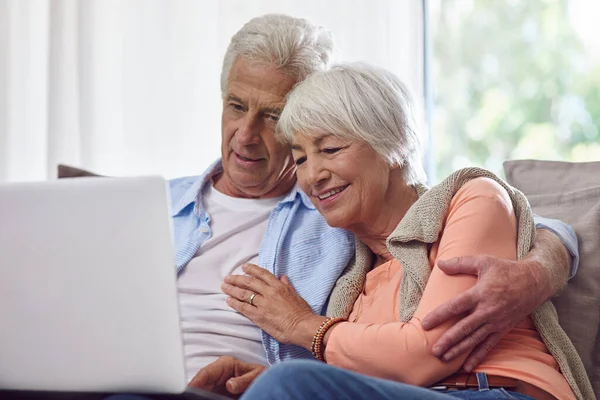 Online movie time is our favorite time of the day. a senior couple using a laptop at home