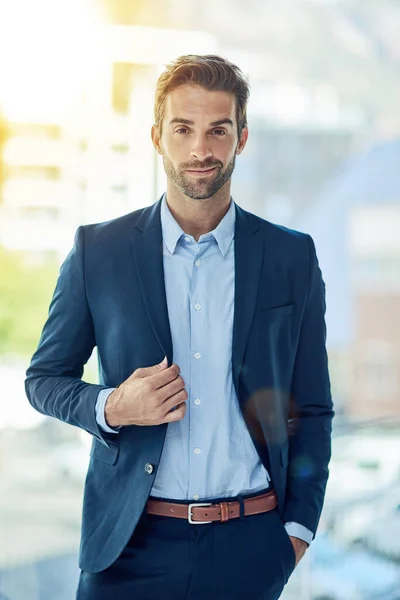 My number one goal is to be number one. Portrait of a young businessman standing in an office