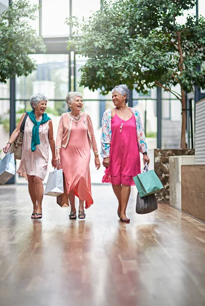 Best friends at the shopping mall. Full length shot of a three senior women out on a shopping spree