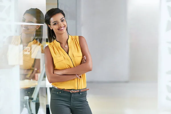 Stay positive. Cropped portrait of an attractive young businesswoman standing with her arms crossed in the office