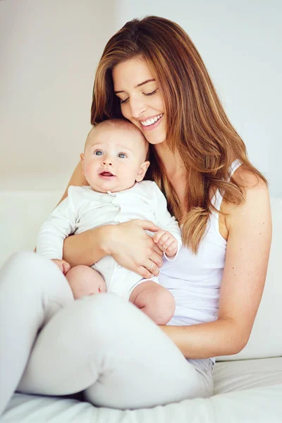 I love you to the moon and back. a young mother bonding with her adorable baby boy at home