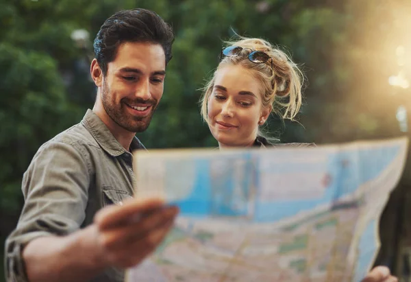 Life takes you to unexpected places, love brings you home. a young couple using a map while exploring the city
