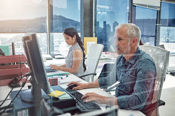 Working side by side. two colleagues working in the office