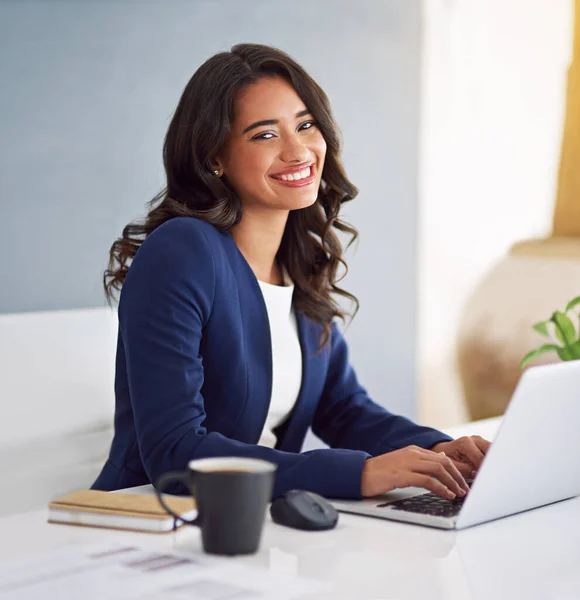 Living my dream. Cropped portrait of a young businesswoman working on her laptop