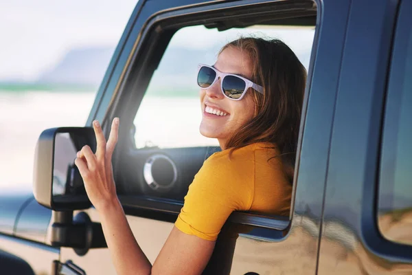 Life is a journey, enjoy the ride. a young woman sitting in her car