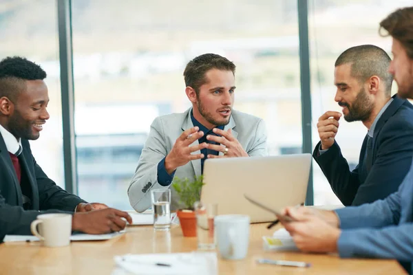 Shared vision, shared success. a team of colleagues having a meeting around a laptop in a modern office