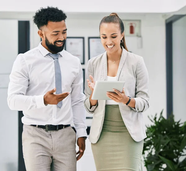 Business people, collaboration and teamwork with tablet in office for walking man and woman planning corporate strategy. Happy employees with smile, motivation or success vision on digital technology.