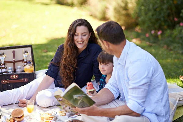 The perfect day for a picnic. a family enjoying a picnic together