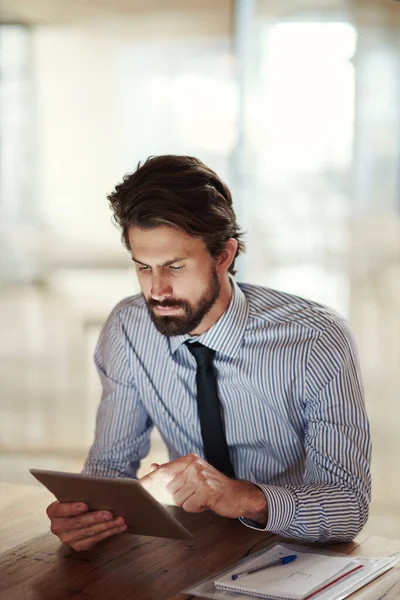 Its like an office within an office. a businessman using a digital tablet