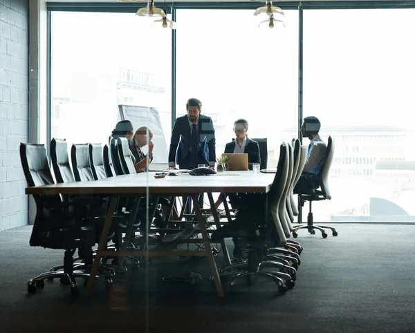 Collaborating for company success. a group of executives having a meeting in a boardroom
