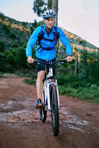 Setting out on his bike ride. a male cyclist riding along a mountain bike trail