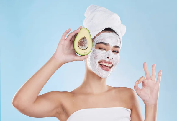 Skincare, beauty and ok sign for avocado face mask with beautiful woman taking care of healthy skin. Organic, fresh and cleansing facial with routine treatment and natural ingredient for good results.