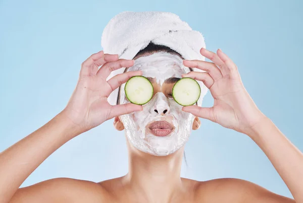 Skincare, beauty and face mask with cucumber slice on a beautiful woman taking care of her clean, healthy and natural skin. Fresh, wellness and relax during routine pamper spa cosmetology treatment.