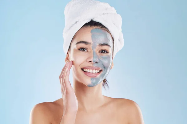 Beauty, skincare product and face mask with a portrait of a beautiful woman taking care of her clean, healthy and happy skin. Smile, charcoal or clay exfoliate during routine hygiene treatment.