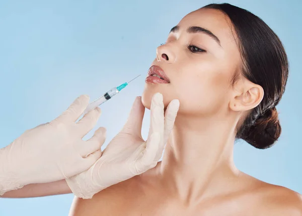 Plastic surgery, botox and lip filler on woman for facial beauty aesthetic and medical cosmetic. Hands and female face augmentation surgeon or doctor working on patient lips with injection needle