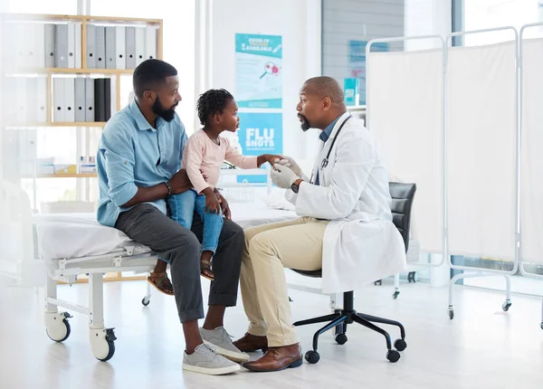 Black doctor, medicine and medical worker consulting with baby, father and child patient for covid, allergies or hospital. Nurse, trust and support African family wellness healthcare for health help.