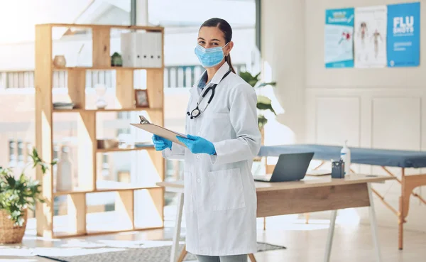 Insurance checklist and covid healthcare doctor with face mask and portrait while working with medical paperwork in an office. Trust and vision of a covid 19 expert woman checking vaccination results.