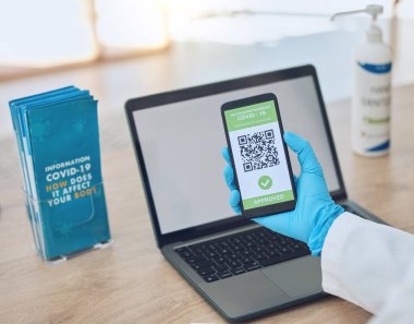Covid, vaccine and passport on smartphone for travel, safety or security during virus pandemic. Laptop, hands and phone app with digital corona QR code for international, global and safe traveling