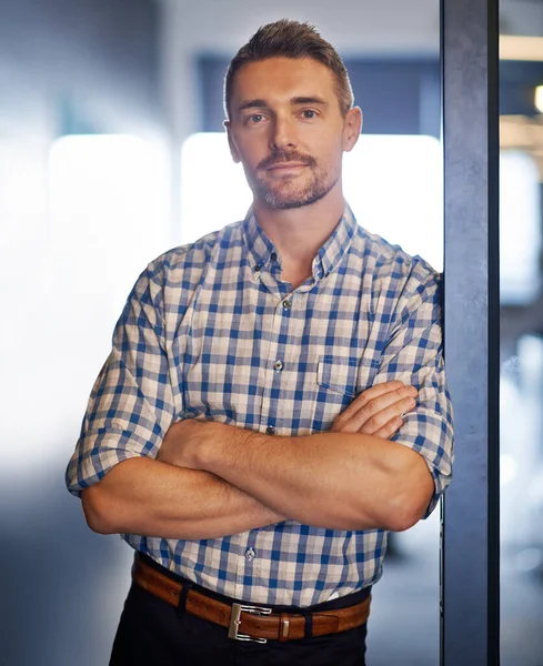 Ill get the job done for you. Portrait of a businessman standing with his arms crossed in the office