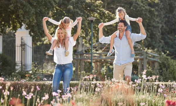 Mother, father and kids in a garden as a happy family outdoors in summer to relax, bond and have fun together. Flowers, children and young girls with mother and father playing in nature in spring.