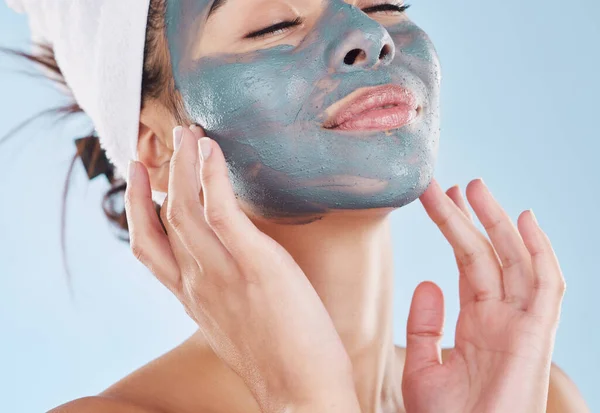 Charcoal face mask for healthy skincare, wellness of facial skin and beauty product for body care against blue mockup studio background. Mock up of relax, cosmetic and lifestyle model with treatment.