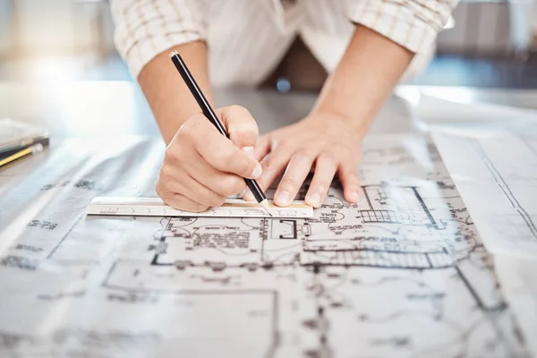 Architect drawing building floor plan, design blueprint map and engineer drafting structure on table paper. Real estate development work office construction and industrial wall safety ruler.