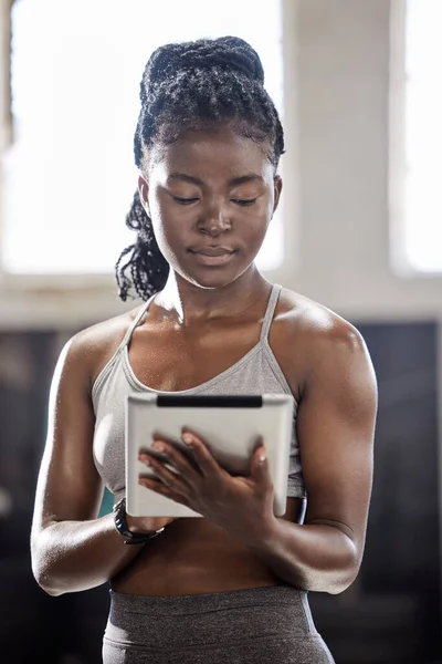 Personal trainer with digital tablet, mobile wellness technology in gym and black woman exercise in fitness gym. Sports athlete online, workout coach and internet training motivation.