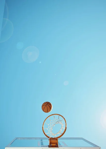 Basketball, sport and training with a ball and net isolated on a clear sky with mockup from below. Sports, fitness and exercise on a court outside for marketing and advertising on a blue background.