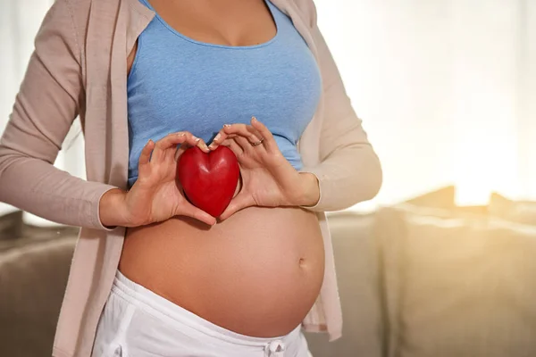 Love Begins Birth Pregnant Woman Holding Red Heart Front Her — Stock fotografie