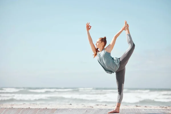 Health, fitness and yoga with woman meditation pose at a beach, stretching and training workout. Flexible female practice balance, energy and posture in nature, relax with zen and peace mindset.