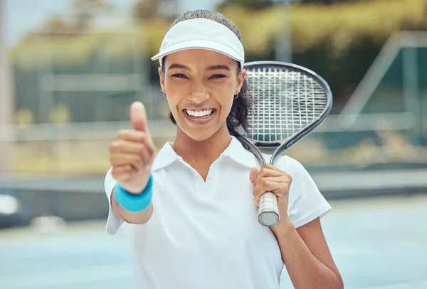Tennis, woman and thumbs up, happy smile after training, workout or fitness activity on court. Girl motivation, achievement and success, champion cheerful outdoors after winning a game