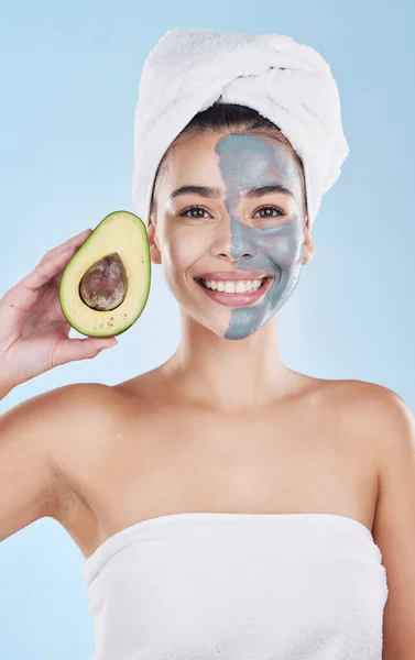 Avocado face mask for beauty skincare, food for skin health and product for nutrition diet against blue mockup studio background. Portrait of happy, healthy and Brazilian girl with cosmetic fruit.