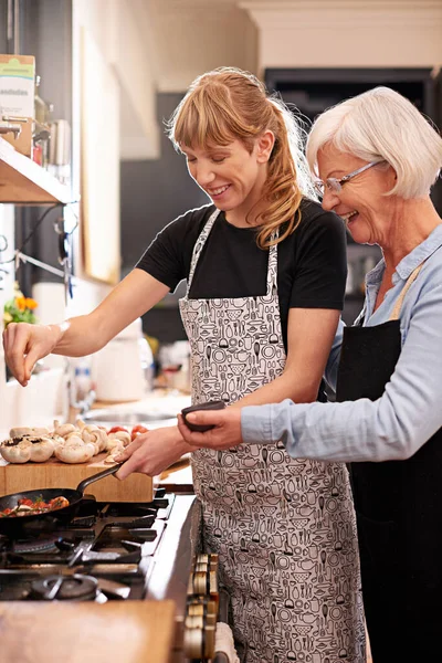 Just Dash Senior Woman Younger Woman Cooking Together — kuvapankkivalokuva