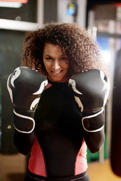 Youve met your match. Portrait of a young woman wearing boxing gloves for a workout