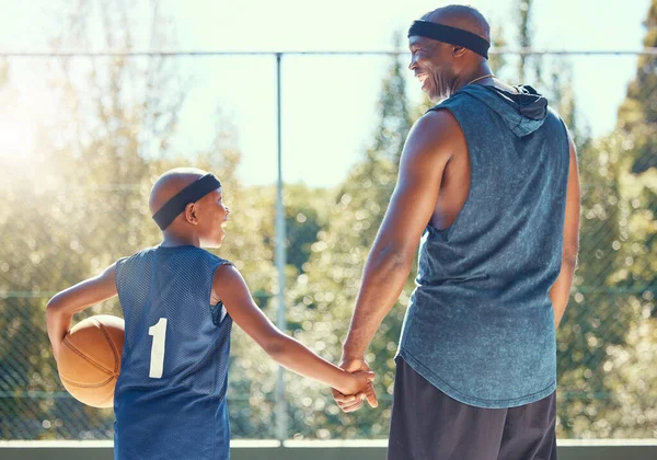 Basketball, family and sport with a dad and son training on a court outside for fitness and fun. Children, exercise and workout with a father and boy playing basket ball for health and recreation.
