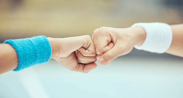 Fist bump, celebration of sport success and motivation hands for tennis player on court for sports game, support during competition and team collaboration. Partnership, trust and goal in training.