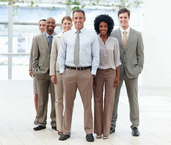 Great leader makes a great team. Full length of a diverse business team standing confidently with their team leader