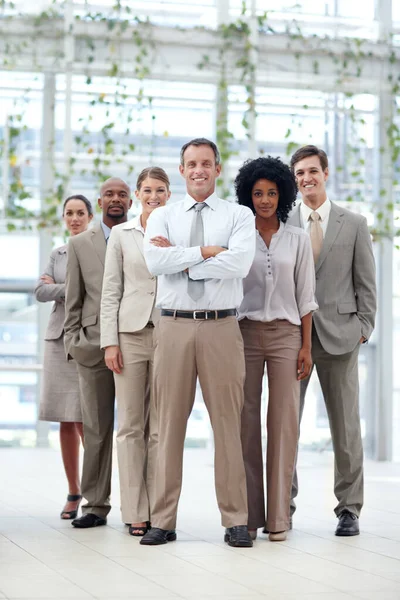 Unstoppable business force. Full length of a dynamic business team standing confidently with their team leader - Copyspace