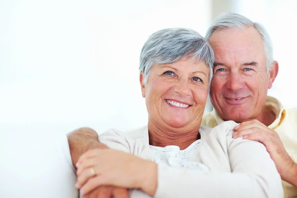 Sheer joy. Closeup of cheerful mature couple laughing together while sitting at home