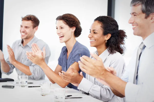 Heres to another successful quarter. Profile shot of a group of young business people clapping hands at a meeting