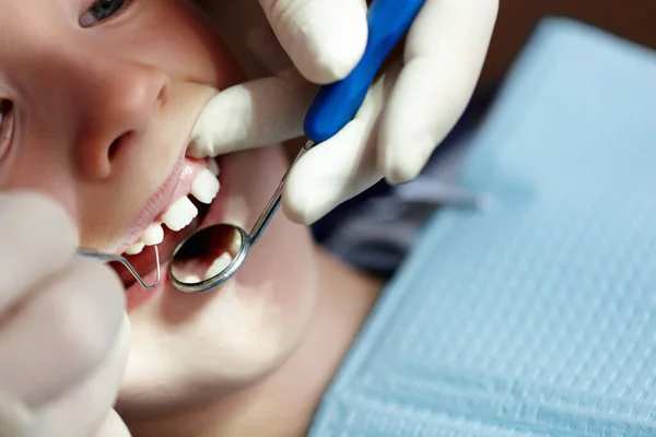 Boy taking dental treatment. Closeup of young boy taking dental treatment in clinic