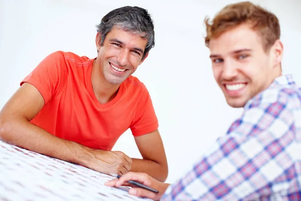 Two smiling photographers. Portrait of two photographers looking at you and smiling