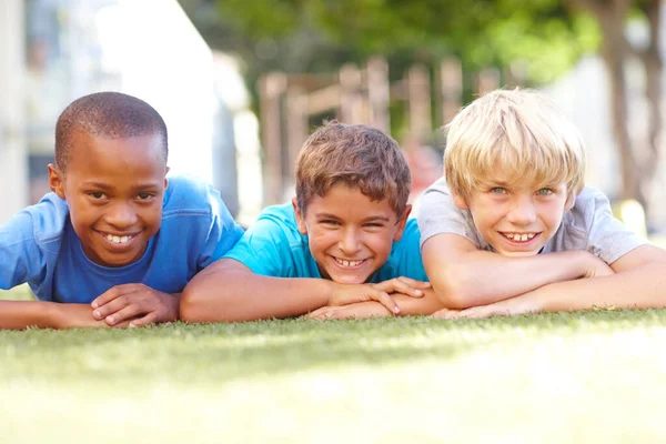 休憩時間の仲間 晴れた日の午後に芝生の上に横たわっている3人のかわいい男の子の肖像画 Copyspace — ストック写真