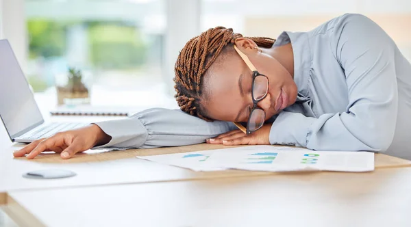 Sleeping, tired or burnout black woman in finance office with desk laptop or infographic documents. Exhausted, overworked or depression for accounting compliance employee in financial audit business.