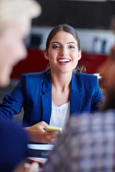 Shes an ambitious young professional. Portrait of a young creative professional in a meeting with her coworkers