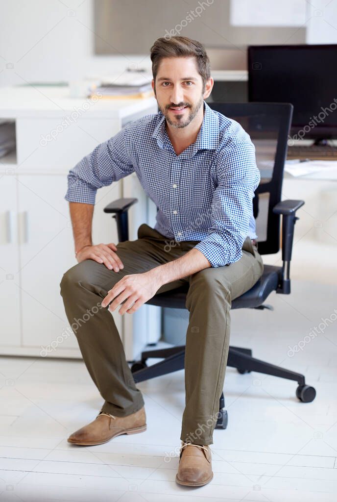 Youre looking at of the best in the biz. Portrait of a young designer sitting at his workstation in an office