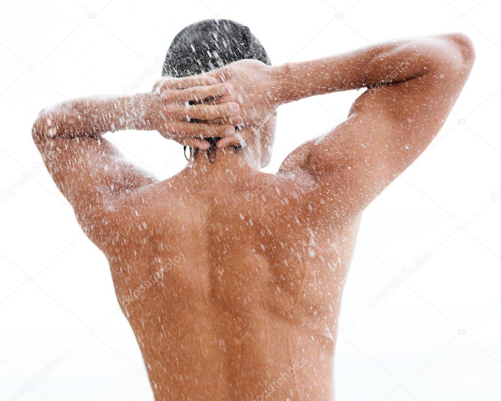 Revitalized and refreshed. a handsome young man enjoying a refreshing shower