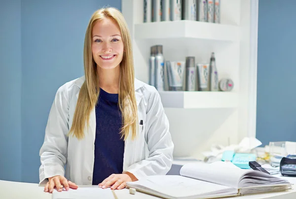 I guarantee you will leave here looking great. Portrait of an attractive young woman at the counter of a cosmetics store