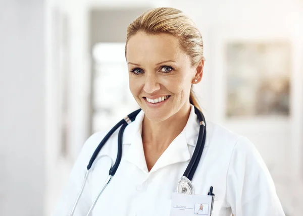 Youre in good hands. Cropped portrait of an attractive female doctor standing in the hospital corridor