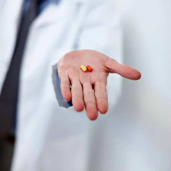 Dont depend on it. a doctor holding two capsules in his hand